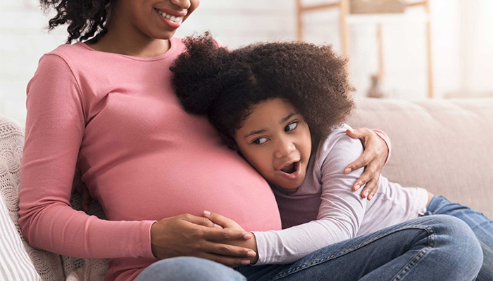 pregnant woman and daughter