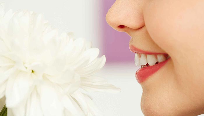 woman smelling flower